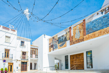 Picturesque square Plaza de la Villa and church of Nuestra Senora de las Nieves surrounded by charming buildings located in the heart of Calpe old town, Alicante province, Valencian Community, Spain