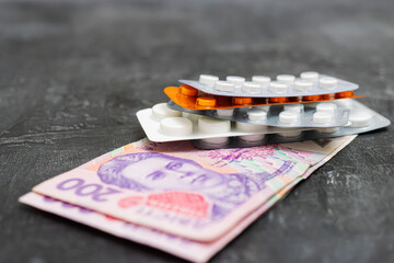 Blister packs with tablets or pills, antibiotic, painkiller or drugs and money, Ukrainian Hryvnia...