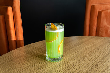 Close up of organic green apples and kiwi green fresh juice in glass with fresh oranges.