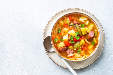 Minestrone soup, italian vegetable soup with smoked sausages, Top view.