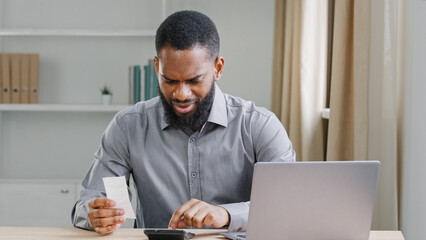 Serious African American ethnic man bearded businessman manage business company finance checking...