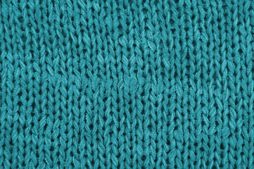 blue unusual texture.knitted turquoise sweater close up. handmade concept