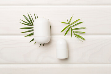 Natural deodorants on wooden background, top view