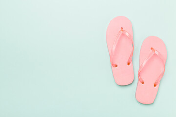 Bright flip flops on color background, top view