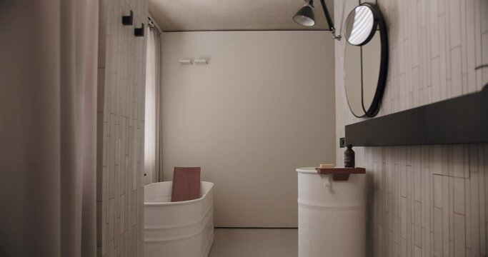 Luxury Bathroom Interior, minimalist interior in white colors with bathroom accessories , mirror and shower head, round mirror in modern interior, bathtub modern design