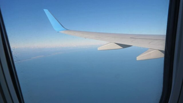 Airplane wing. Air View from plane window on sea. Travel and transport concept. Nobody