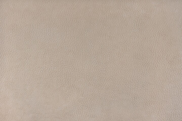 Texture background of beige velours fabric textured like leather surface. Fabric texture close up of upholstery furniture textile material, design interior, wall decor, backdrop, wallpaper.