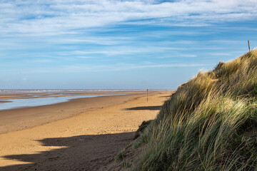 Looking put over Formby beach at low tide, on a sunny morning