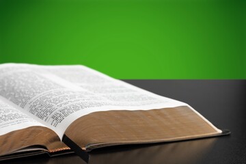 Open Bible book on wooden table