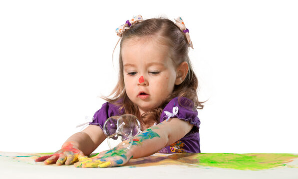 Young girl finger painting