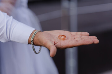 Wedding gold rings on the hands of the newlyweds. Gold rings on the hand of a man and a woman