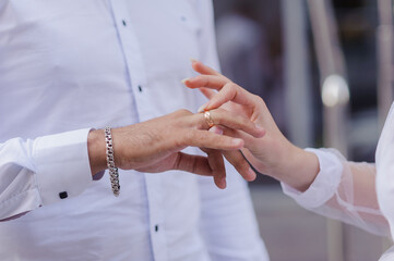 Wedding gold rings on the hands of the newlyweds. Gold rings on the hand of a man and a woman