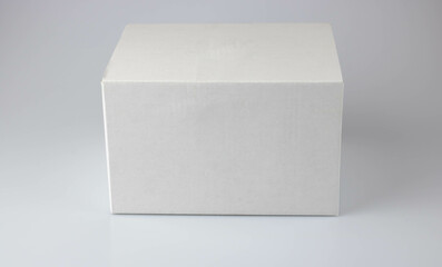 White cardboard box for wrapping gifts on a gray background