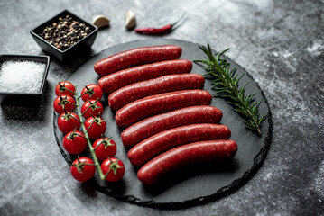 raw beef sausages on stone background