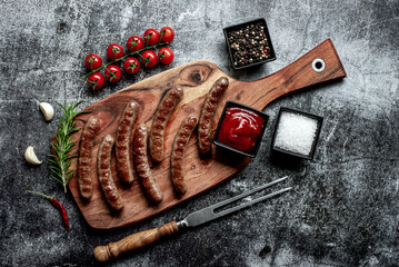 grilled beef sausages on stone background 