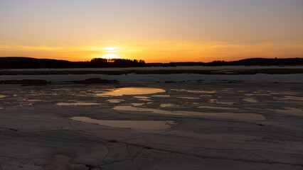 Sunset over a lake in a Canadian forest lake in spring