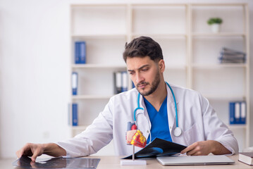Young doctor radiologist sitting at the hospital
