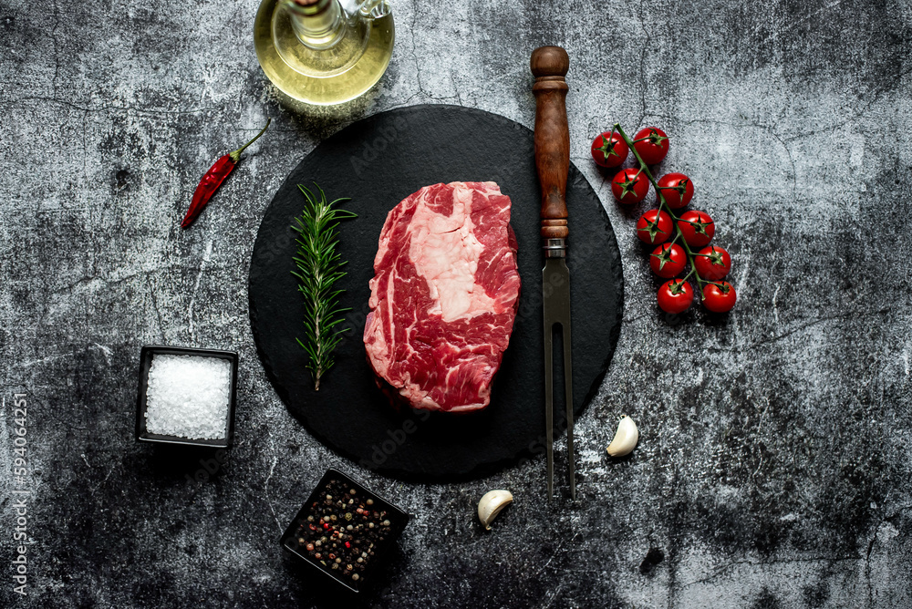 Wall mural raw marbled beef steak on stone background