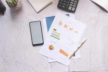 top view of financial chart and smart phone on table 