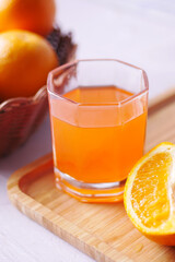orange juice in glass with fresh fruits 