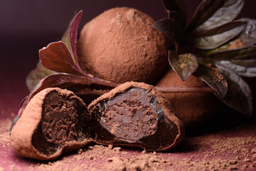 Chocolate sweets, truffle candies on a dark background, close-up.