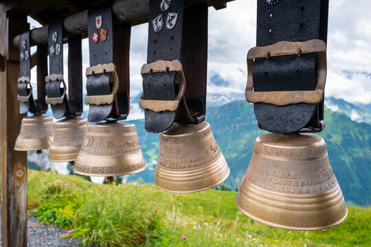 Schynige Platte, Switzerland - July 4, 2022: Hanging  Swiss cow bells  near the Railway station on the top of Schynige Platte, Oberland, Switzerland. 