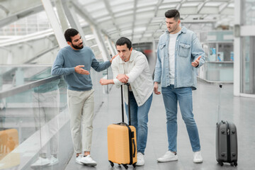 Fototapeta na wymiar Three Men With Suitcase Having Quarrel During Trip In Airport