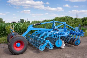 Disc harrow for tillage in areas with the remains of tall stalks of corn and sunflower on the...