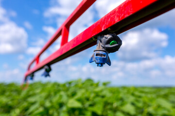 Sprinklers on the bracket of the plant protection sprayer preparing to spray a crop protection...