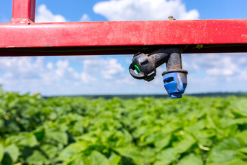 Sprinklers on the bracket of the plant protection sprayer preparing to spray a crop protection...