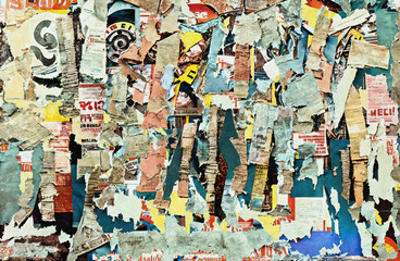 An unintended collage art poster made by different layers of worn and torn street ads on a city wall, piled up over time. Generative AI.
