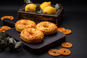 Delicious fresh donuts in yellow glaze with lemon flavor filling