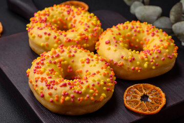 Obraz na płótnie Canvas Delicious fresh donuts in yellow glaze with lemon flavor filling