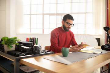 Creative man photographer working at spacious modern studio