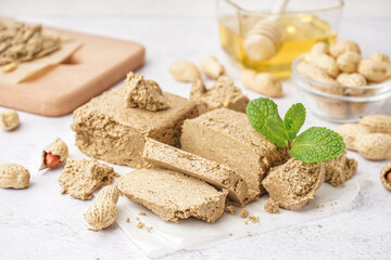 Pieces of sweet halva on light background