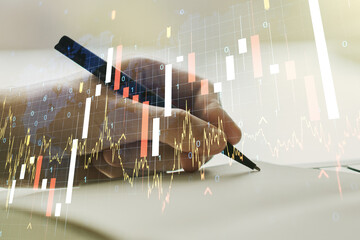 Multi exposure of abstract creative financial graph with world map and with man hand writing in notebook on background, forex and investment concept