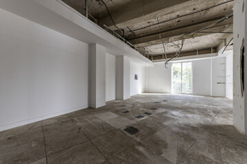 An empty office with all the materials removed, raised floors and cables hung to make a new...