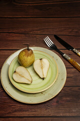 Some porcelain plates in light green tones with some pears for dessert