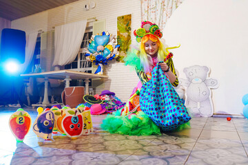 a woman in a stage costume works as an animator at a children's party. 