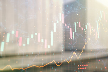 Multi exposure of virtual abstract financial graph hologram and world map on blurry contemporary office building background, financial and trading concept