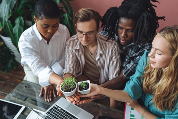 International group of diverse multiracial students working on the biological project, creating new species of plants and flowers. Ecological environmental university college study, experiment, test