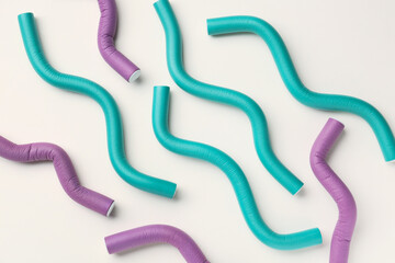 Hair curlers on light background