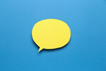 Blank paper speech bubble on blue background