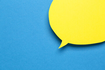 Blank paper speech bubble on blue background