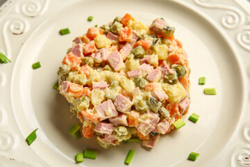 Tasty Olivier salad on plate, closeup