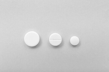 White pills on grey background