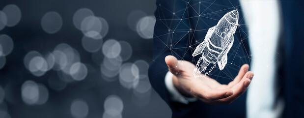 Startup business concept, Businessman holding icon transparent rocket