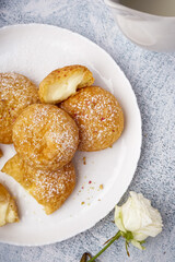 Plate with tasty choux dessert on light background, closeup