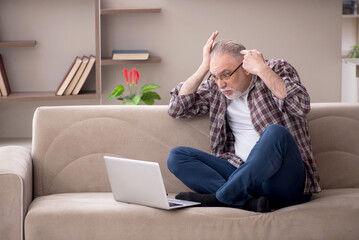 Old man working from home during pandemic