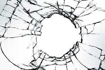 Cracked broken glass on a white background. Damaged window texture with a hole
